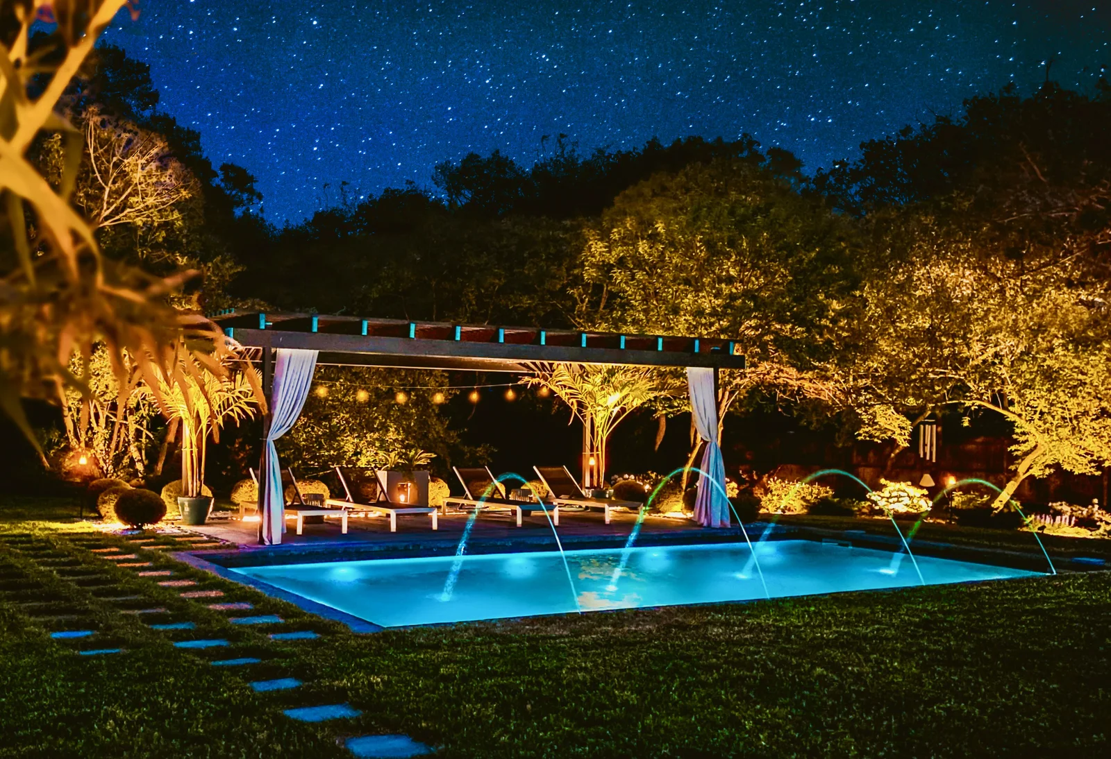 Poolside pergola lit for evening use