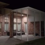 Insulated aluminum Patio cover Extension screened room at night League City, TX