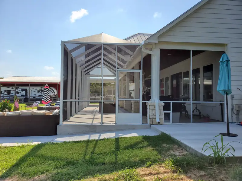 Screened porch enclosure tied into existing roofline in Greater Houston TX