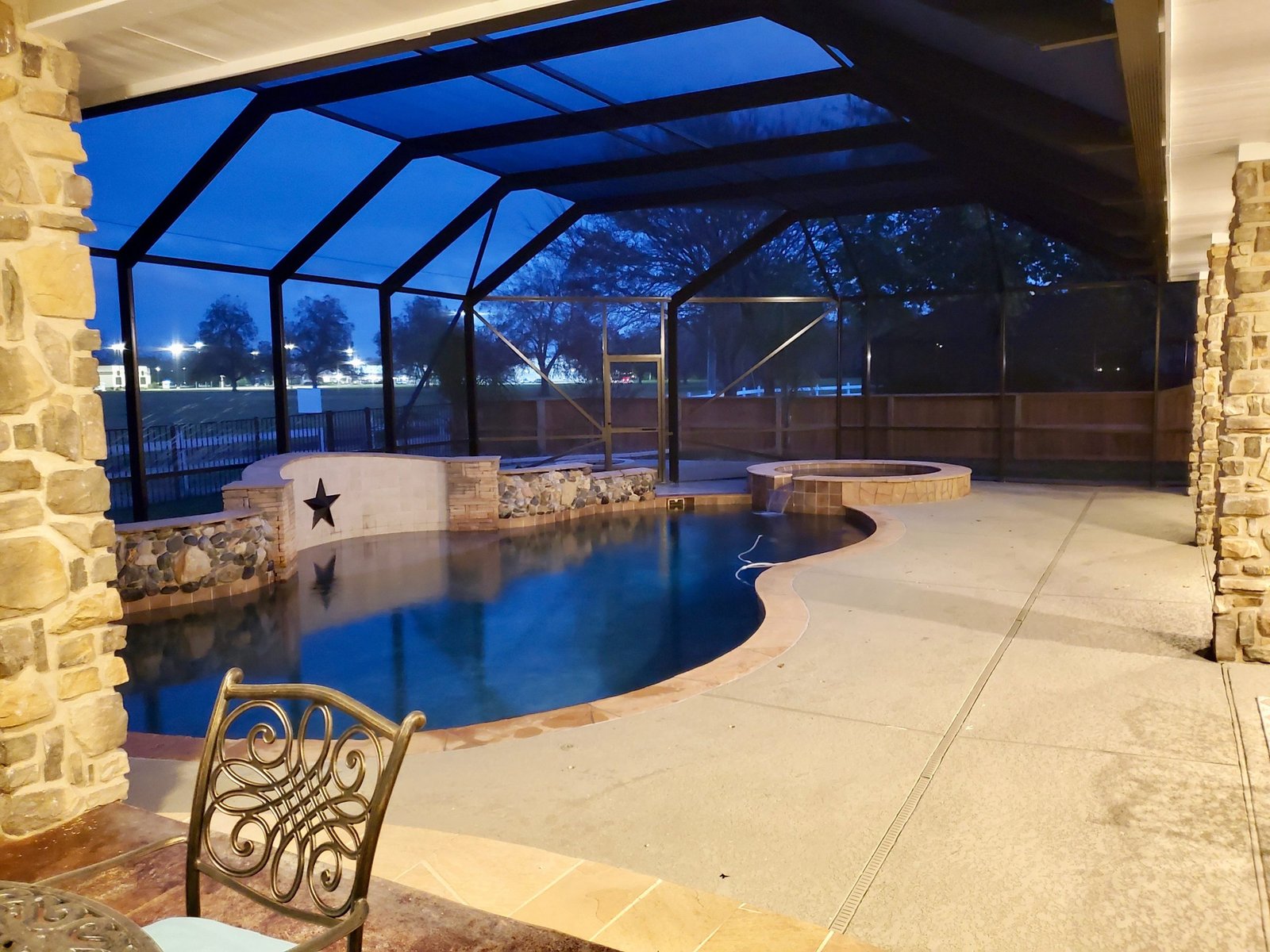 Pool enclosure with evening lighting