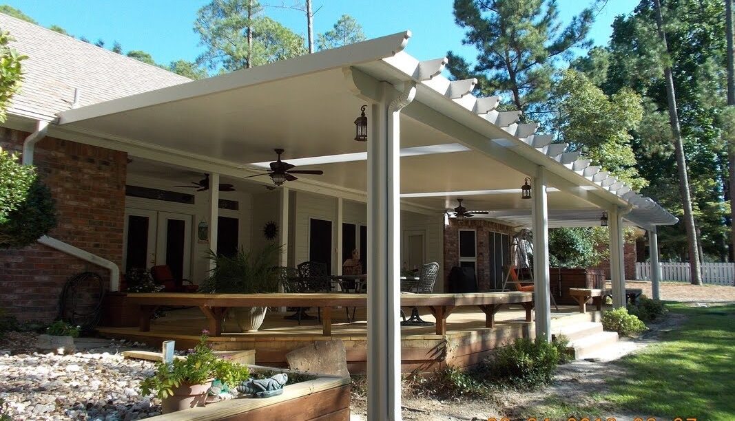 Insulated aluminum patio cover providing shade over a backyard patio on the Texas Gulf Coast