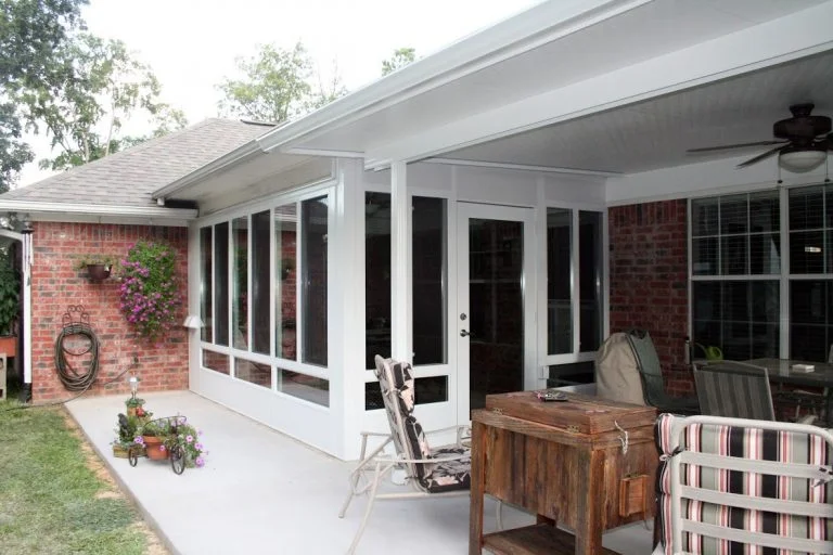 Custom green-tinted glass sunroom built by Simmons Home Design in the Houston area