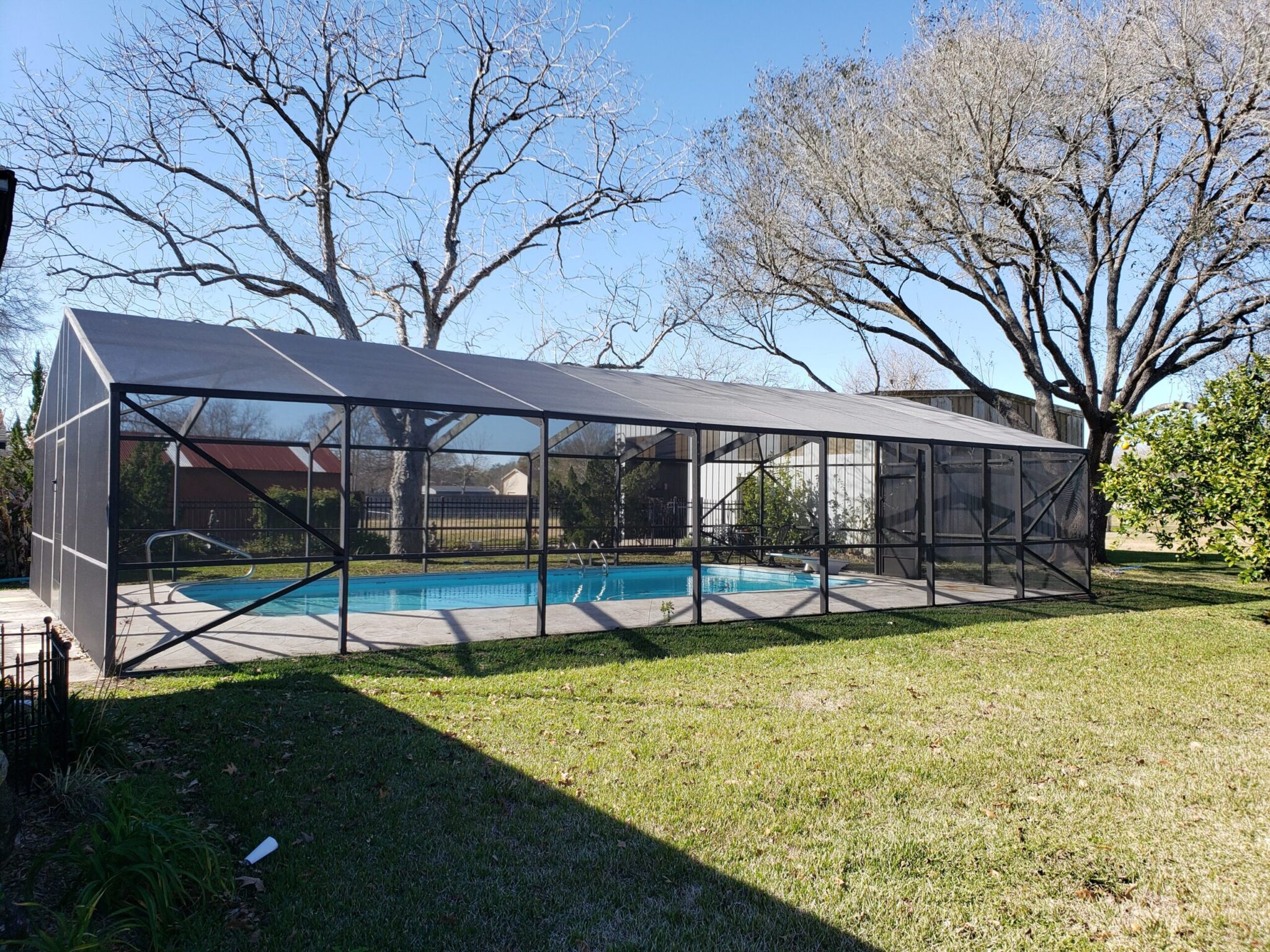 Completed aluminum swimming pool enclosure at a Webster, TX home