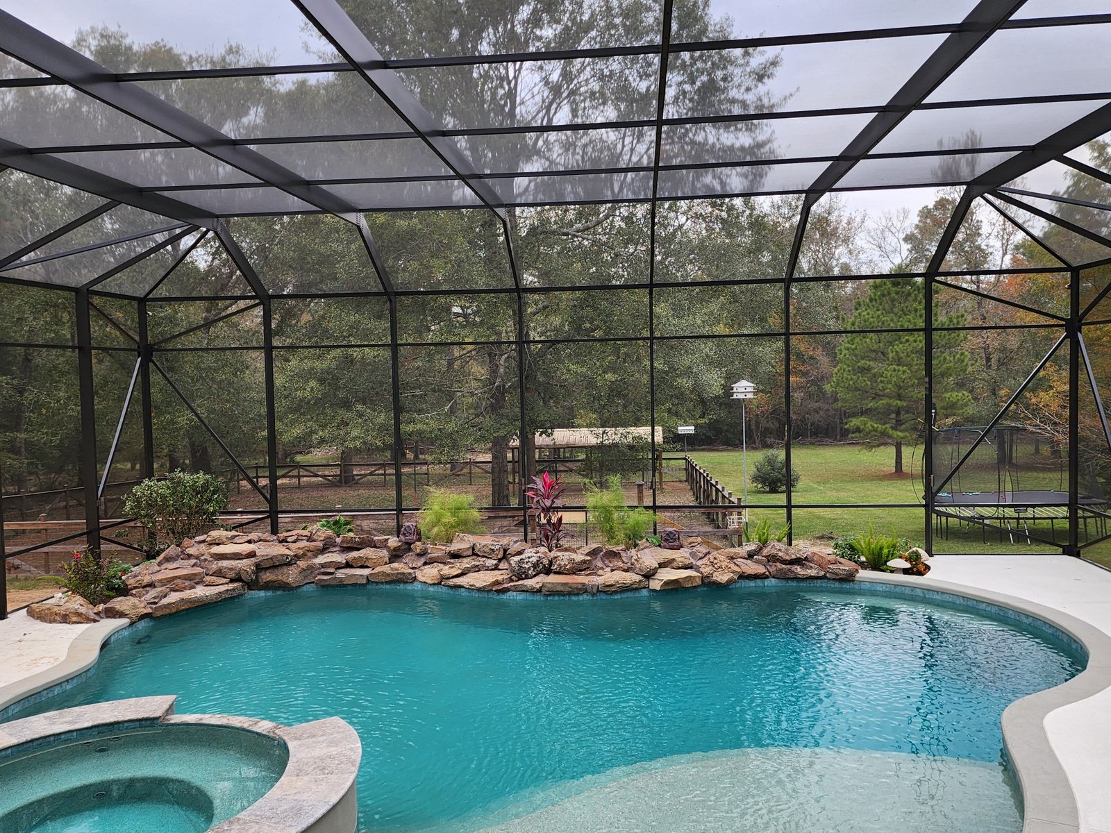 Torn and sagging pool screen panels before repair