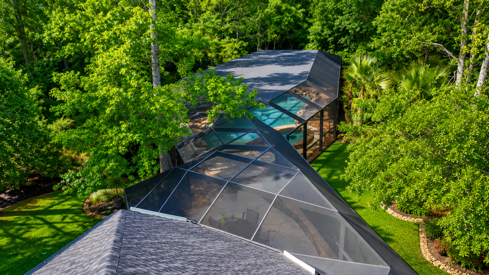 Pool enclosure from top looking down over a backyard pool