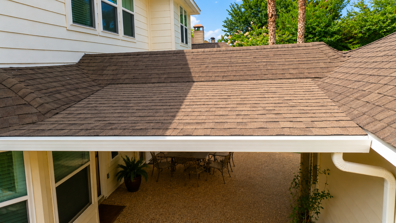 Shaded breezeway roof extension with shingled patio cover